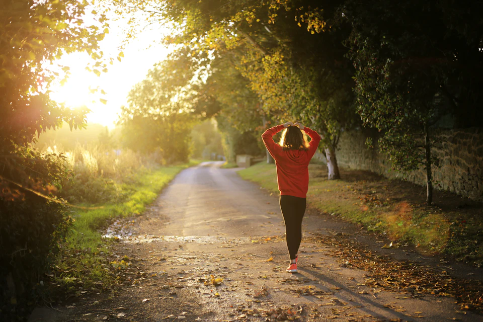 Woman walking on pathway during daytime