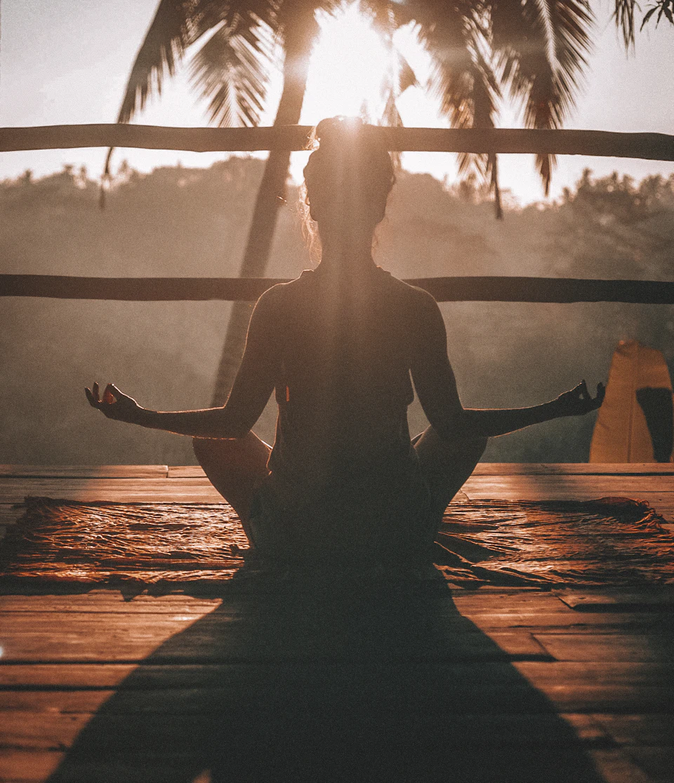 Woman doing yoga meditation on brown parquet flooring