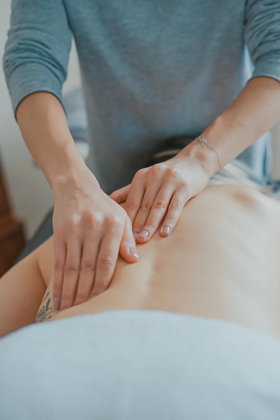 Man massaging woman's body