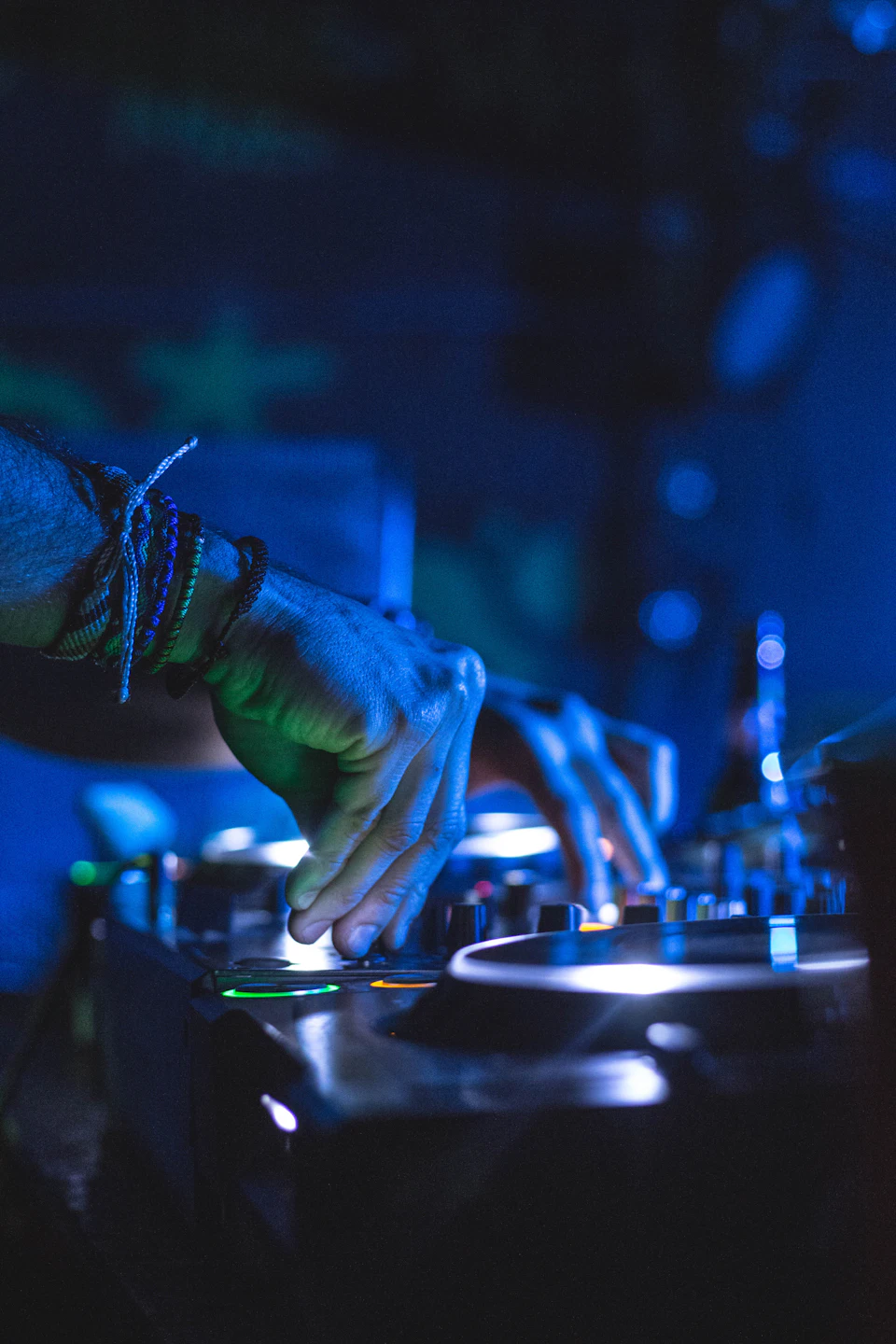 Man controlling DJ controller