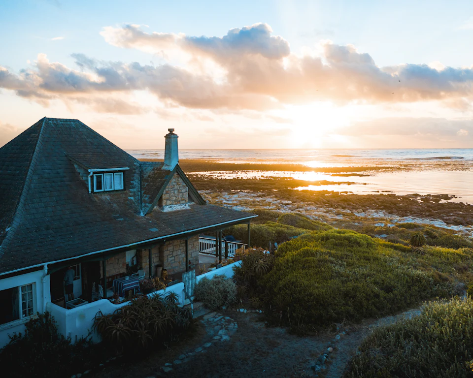 Aerial photo of house near calm body of water