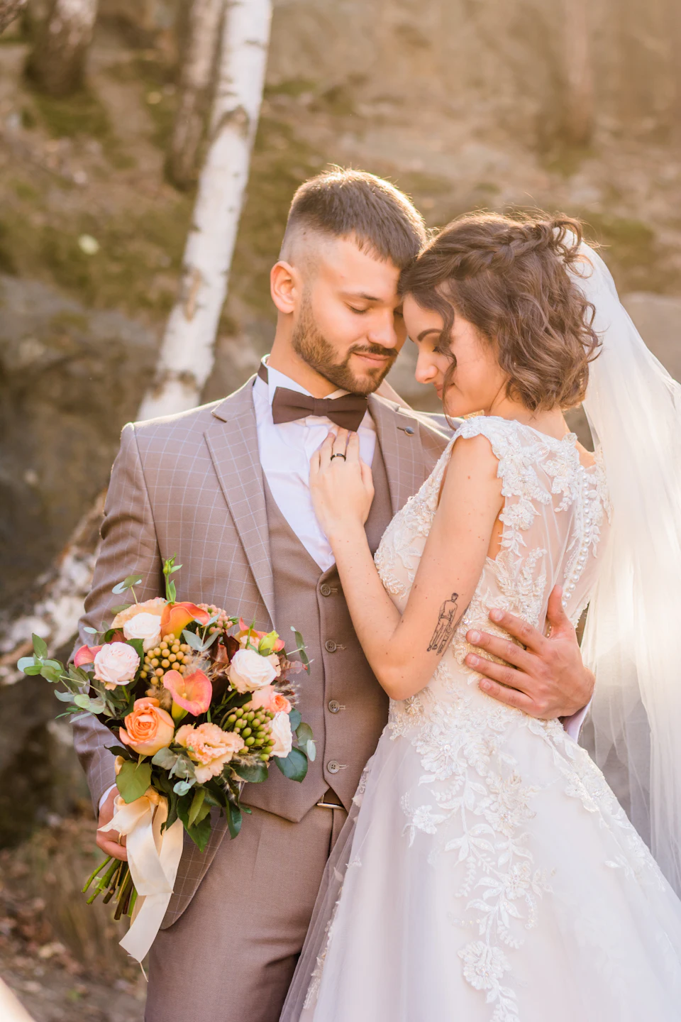 Woman in white wedding dress holding bouquet of flowers