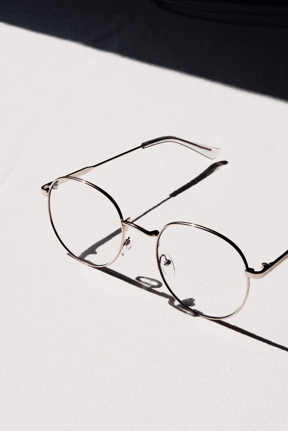 Silver framed eyeglasses on white table