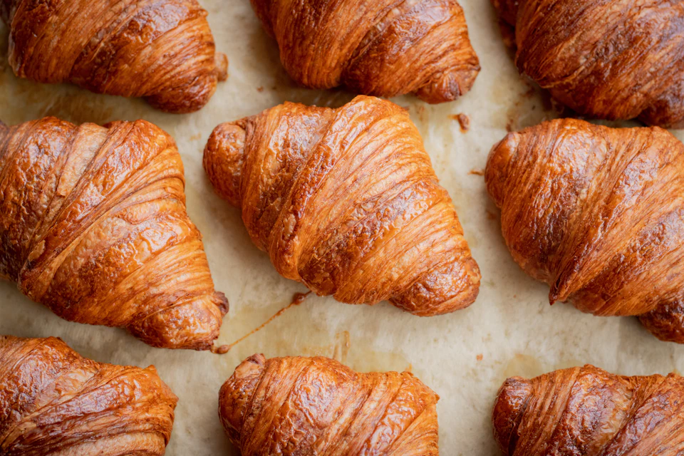 A bunch of croissants that are on a table