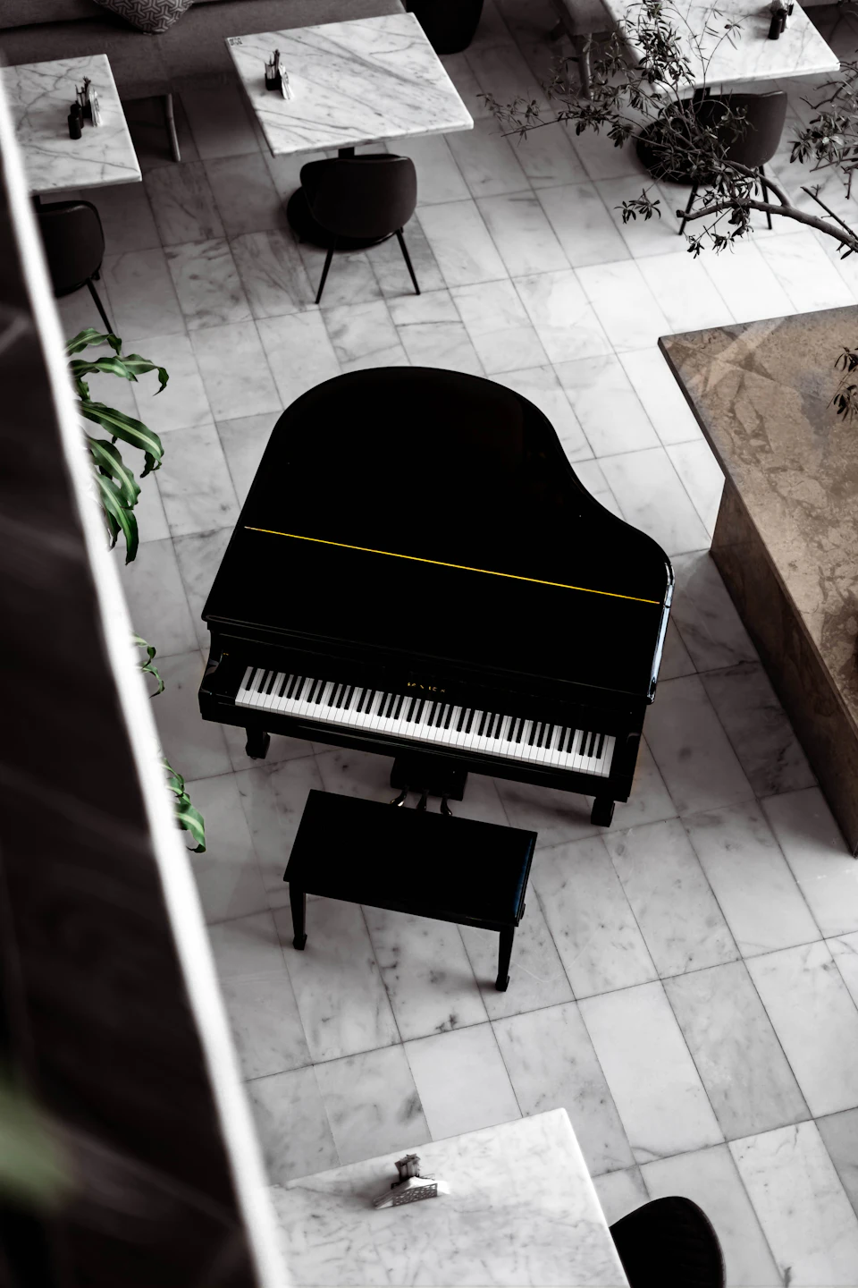 Black grand piano on brown wooden floor