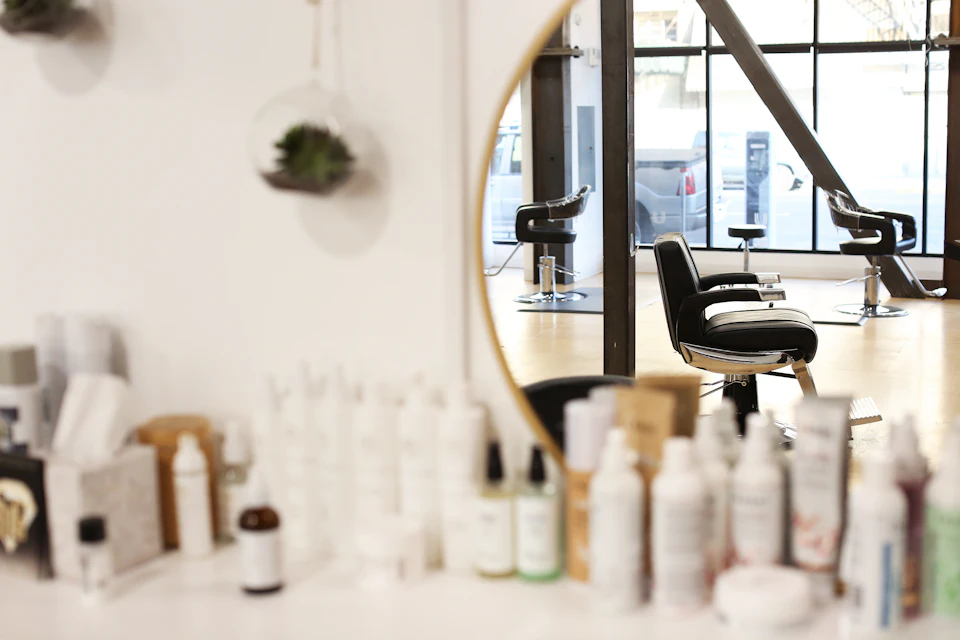 Black and silver office rolling chair beside mirror