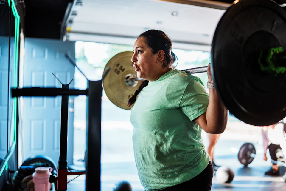 Woman lifting weights in a gym