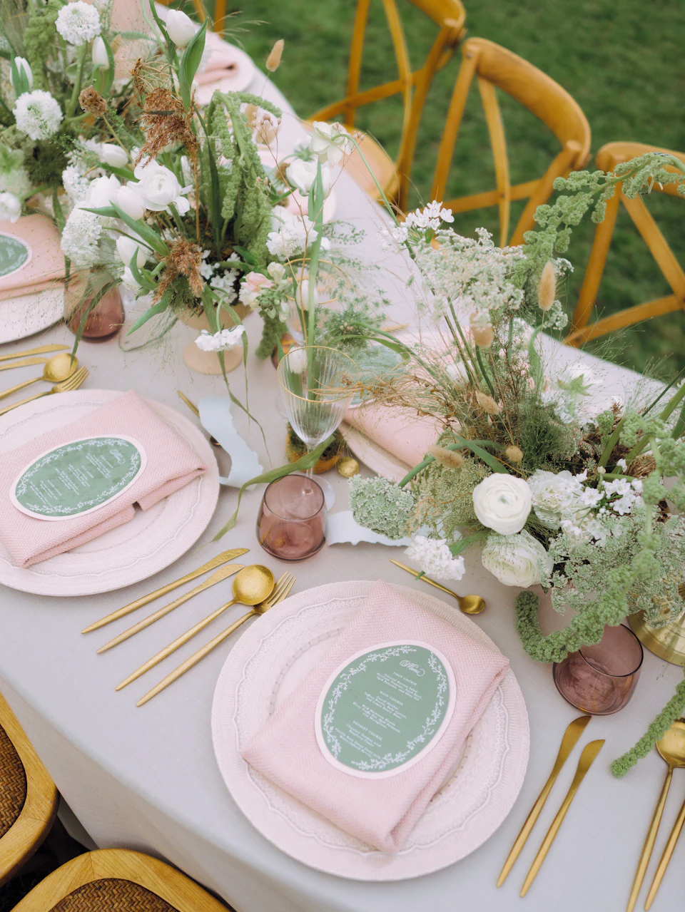 Elegant table setting with floral arrangements and gold cutlery
