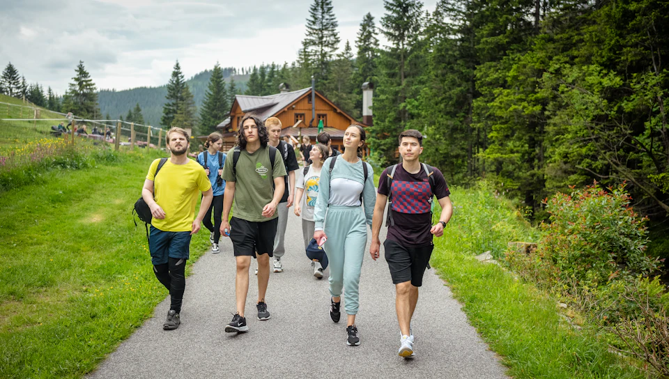 Group of hikers walking on a path in a forest