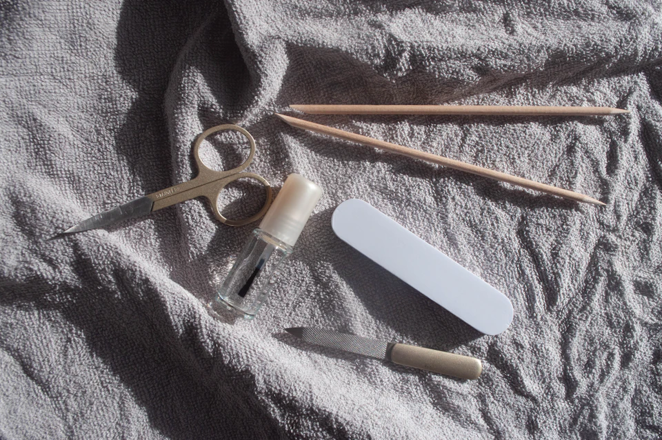 Manicure tools laid out on a white towel